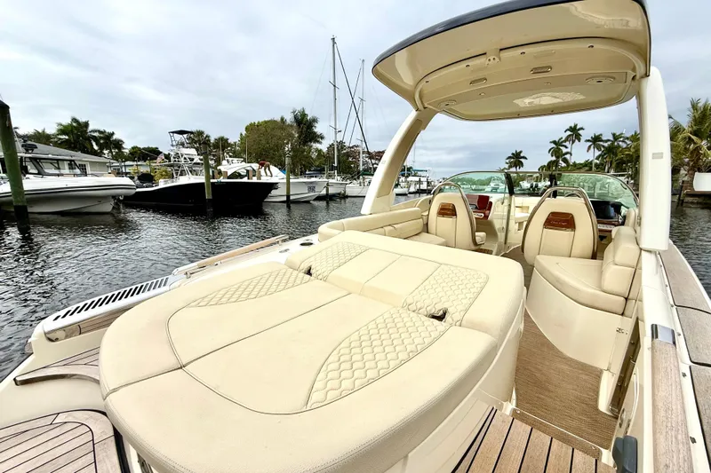  Yacht Photos Pics 2022 Chris-Craft Launch 25 GT boat with luxurious seating at a marina.