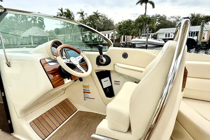  Yacht Photos Pics 2022 Chris-Craft Launch 25 GT boat interior with steering wheel and luxurious seating.