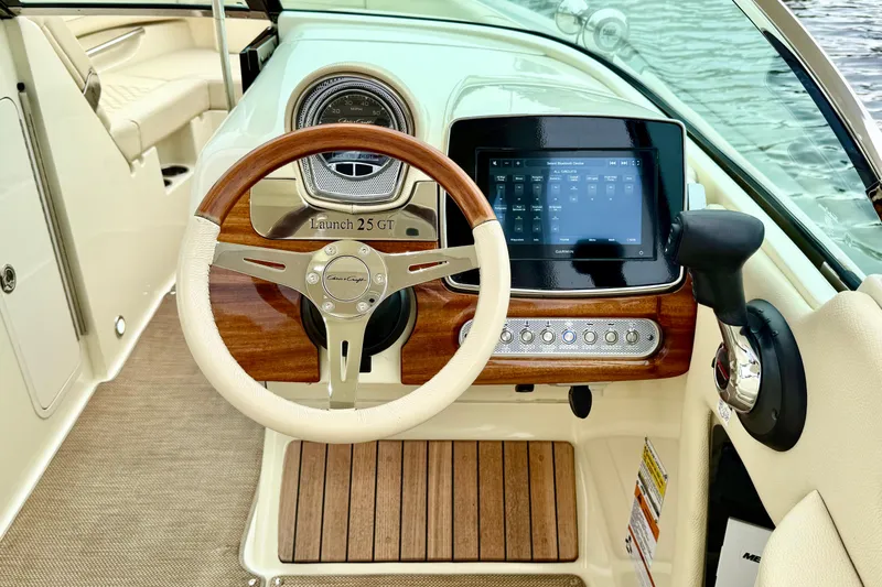  Yacht Photos Pics 2022 Chris-Craft Launch 25 GT dashboard with wooden steering wheel and digital display.