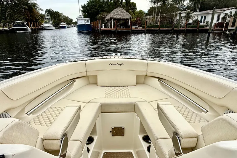  Yacht Photos Pics 2022 Chris-Craft Launch 25 GT boat interior with luxurious seating on a calm waterway.