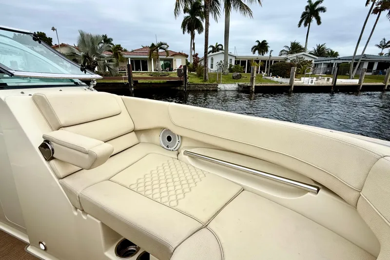  Yacht Photos Pics 2022 Chris-Craft Launch 25 GT boat interior with luxurious seating by waterfront homes.