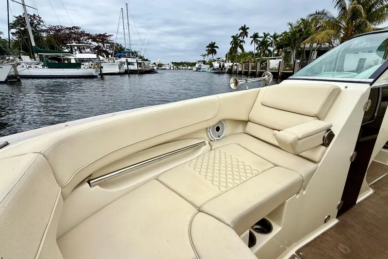  Yacht Photos Pics Luxurious interior of 2022 Chris-Craft Launch 25 GT boat docked by palm trees.