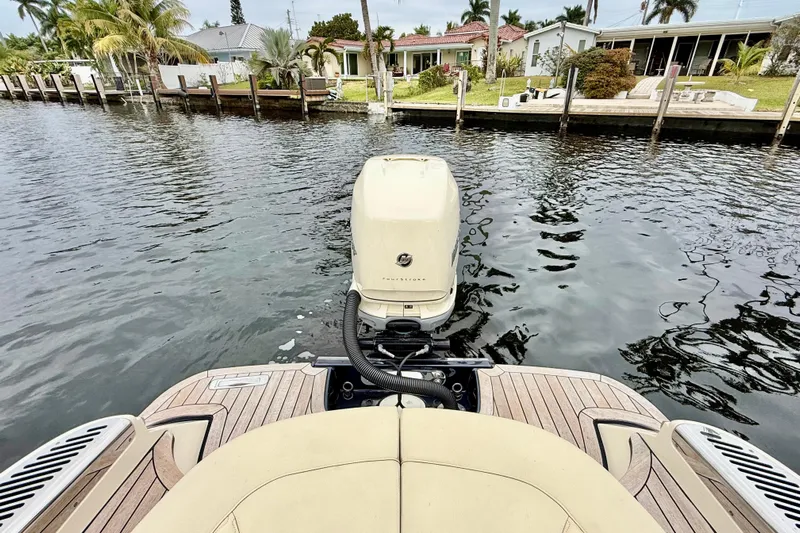  Yacht Photos Pics 2022 Chris-Craft Launch 25 GT boat with outboard motor on a calm waterway.
