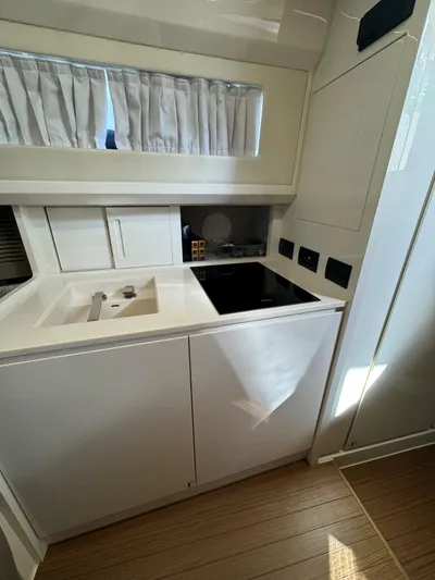 Bb Avanti Yacht Photos Pics 2023 Bluegame BG42 yacht kitchen with modern appliances and sleek white cabinetry.