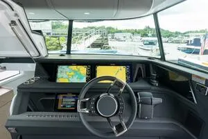 Stock 5 Yacht Photos Pics 2024 Axopar 45 boat cockpit with advanced navigation displays and modern steering wheel.