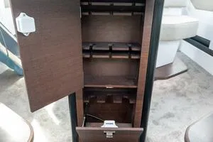 Stock 5 Yacht Photos Pics 2024 Axopar 45 interior cabinet with open wooden doors and storage compartments.