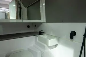 Stock 5 Yacht Photos Pics 2024 Axopar 45 boat interior bathroom with modern fixtures and sleek design.