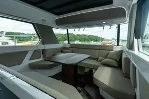 Stock 5 Yacht Photos Pics Interior of 2024 Axopar 45 boat with modern seating and table arrangement.