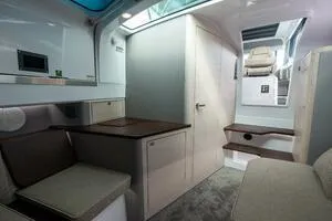 Stock 5 Yacht Photos Pics Interior of 2024 Axopar 45 boat, featuring modern seating and compact dining area.
