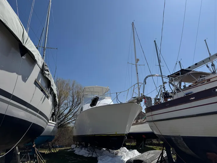  Yacht Photos Pics Boats in dry dock, featuring a 1998 Post 42 Convertible under clear blue sky.