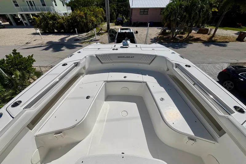  Yacht Photos Pics 2024 World Cat 325 CC boat deck, spacious seating, and sleek design in a sunny outdoor setting.
