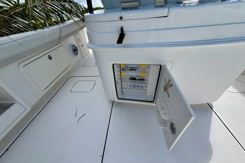  Yacht Photos Pics 2024 World Cat 325 CC boat interior with open storage compartment and speaker.