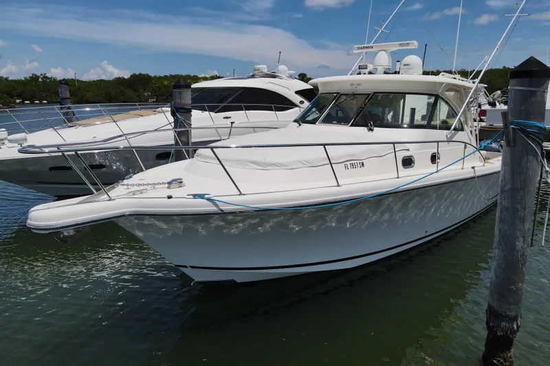  Yacht Photos Pics 2010 Pursuit OS 375 Offshore boat docked in marina, clear sky background.