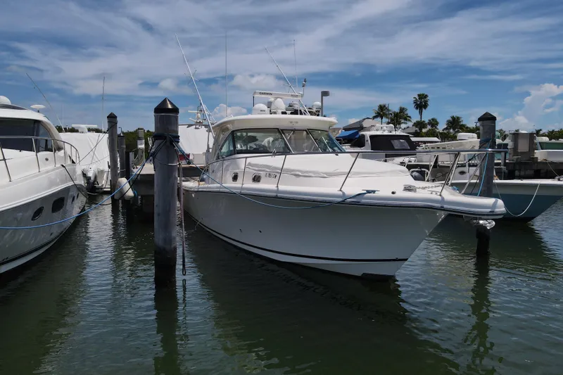  Yacht Photos Pics 2010 Pursuit OS 375 Offshore boat docked at marina under blue sky.