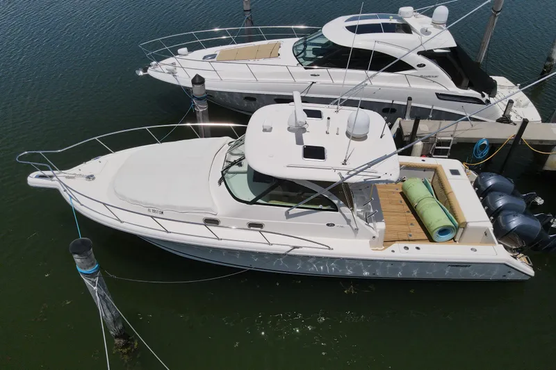  Yacht Photos Pics 2010 Pursuit OS 375 Offshore boat docked, aerial view, with twin engines and spacious deck.