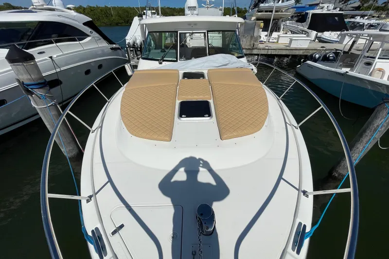  Yacht Photos Pics 2010 Pursuit OS 375 Offshore boat docked, featuring cushioned deck and sleek design.