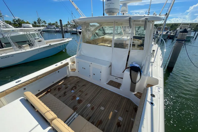  Yacht Photos Pics 2010 Pursuit OS 375 Offshore boat docked at marina, featuring spacious deck and seating.