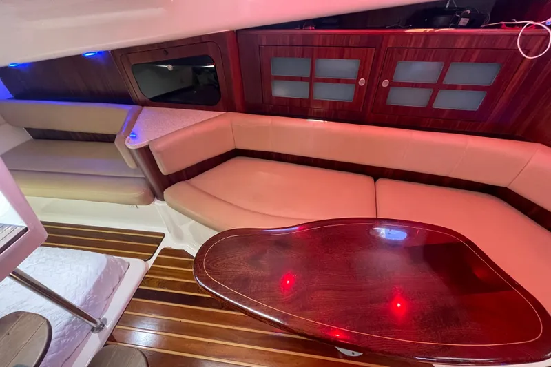  Yacht Photos Pics Luxurious interior of 2010 Pursuit OS 375 Offshore with elegant wood and leather seating.