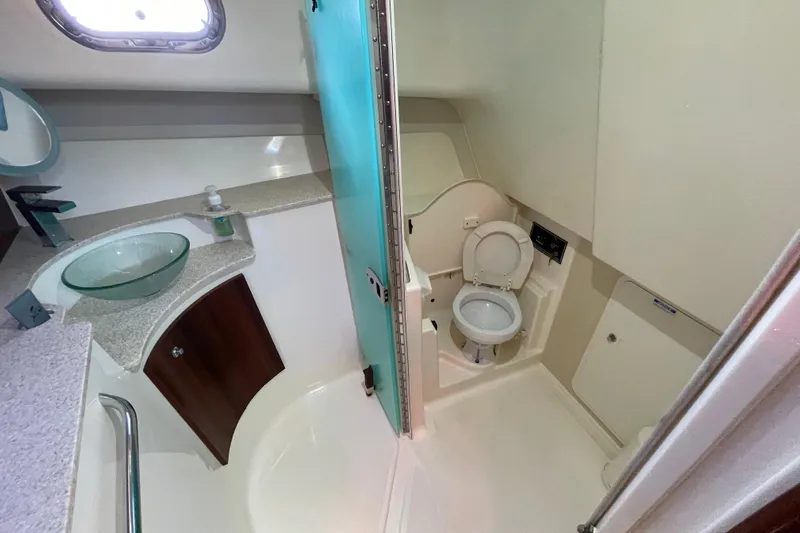  Yacht Photos Pics 2010 Pursuit OS 375 Offshore boat bathroom with modern fixtures and glass sink.