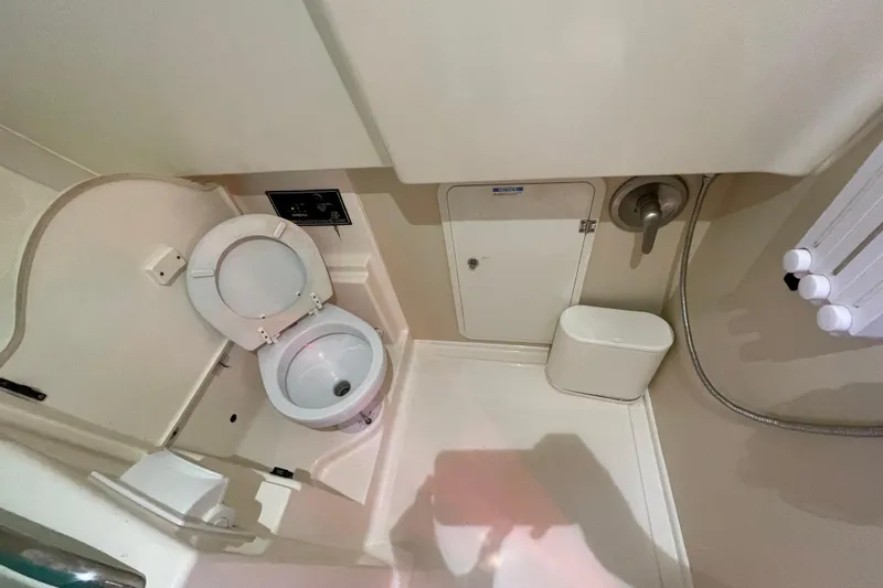  Yacht Photos Pics 2010 Pursuit OS 375 Offshore boat bathroom with toilet and shower amenities.