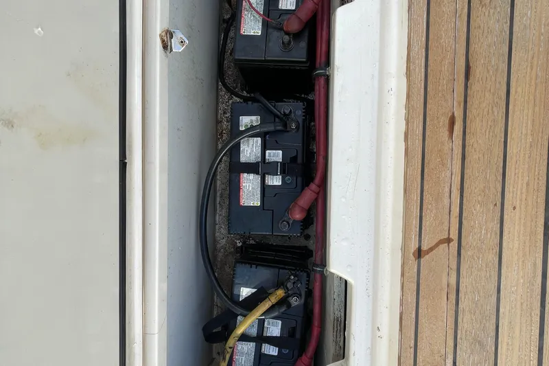  Yacht Photos Pics Batteries in a 2010 Pursuit OS 375 Offshore boat compartment, with wooden deck.