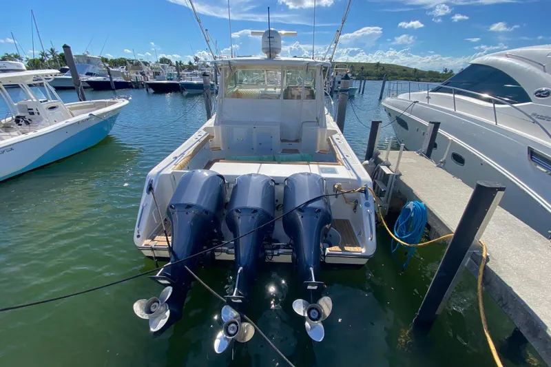  Yacht Photos Pics 2010 Pursuit OS 375 Offshore boat docked with triple outboard engines.