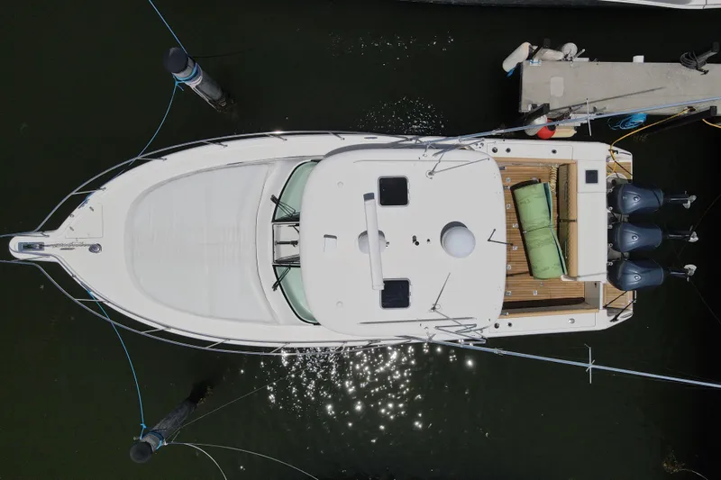  Yacht Photos Pics Overhead view of a 2010 Pursuit OS 375 Offshore boat docked at a marina.