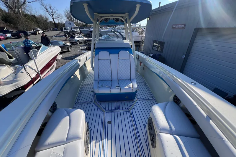  Yacht Photos Pics 2014 Statement 350 Open boat interior with blue and white seating, docked outdoors.