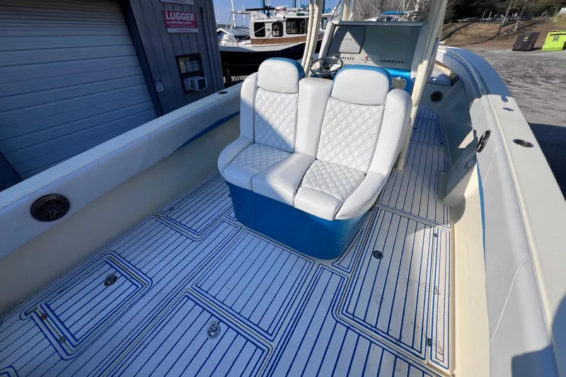  Yacht Photos Pics 2014 Statement 350 Open boat interior with white seating and striped flooring.