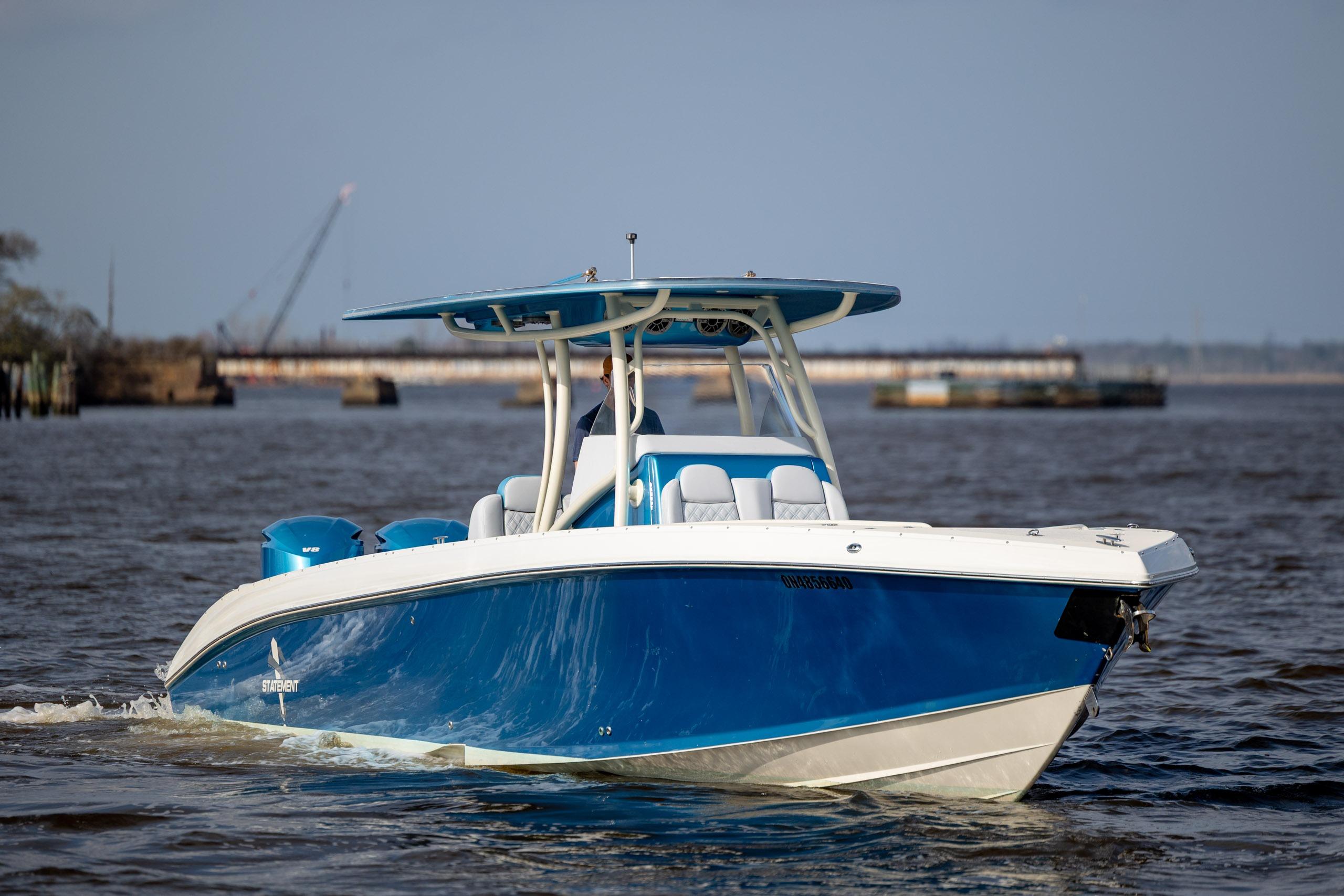 Blue 2014 Statement 350 Open boat cruising on a calm river.