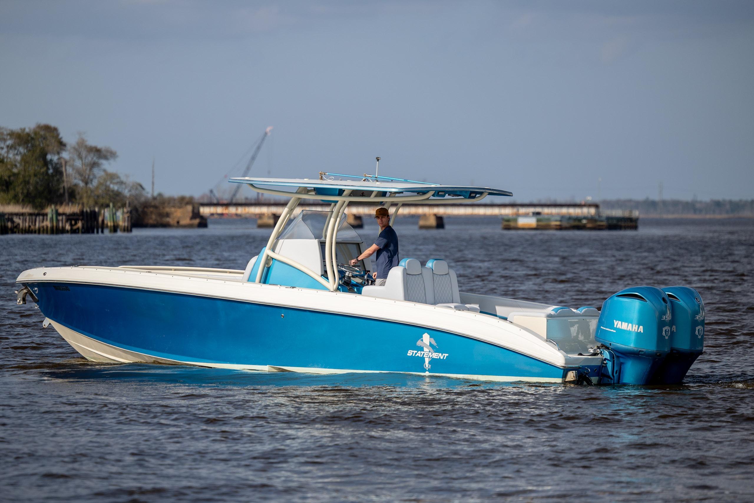 2014 Statement 350 Open boat with Yamaha engines on calm water.