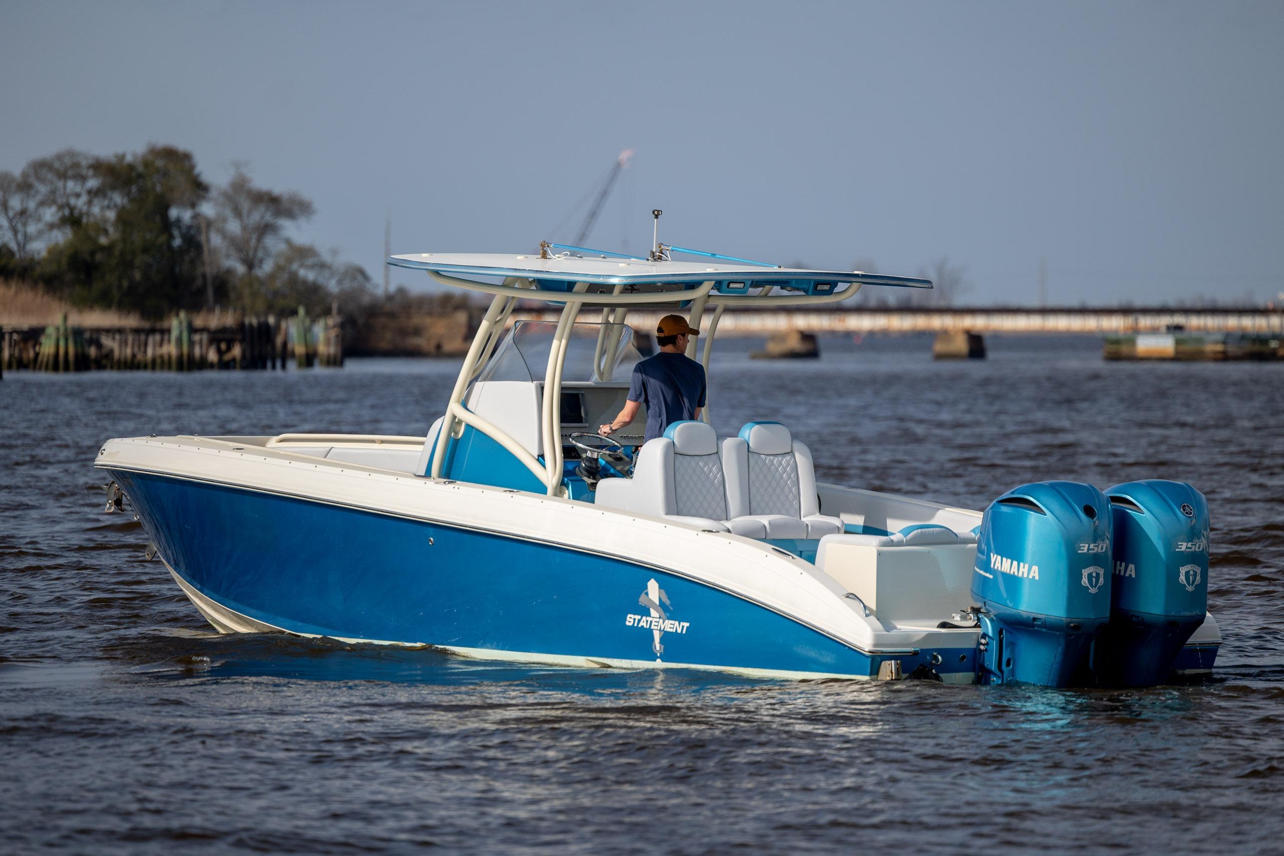 Blue 2014 Statement 350 Open boat with twin Yamaha engines on the water.