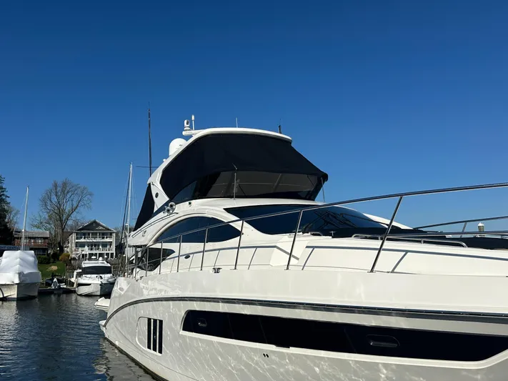 Working Late Yacht Photos Pics 2016 Sea Ray L590 Fly yacht docked under clear blue sky.