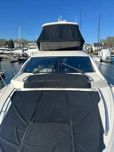 Working Late Yacht Photos Pics 2016 Sea Ray L590 Fly yacht docked in marina, featuring sleek design and spacious flybridge.