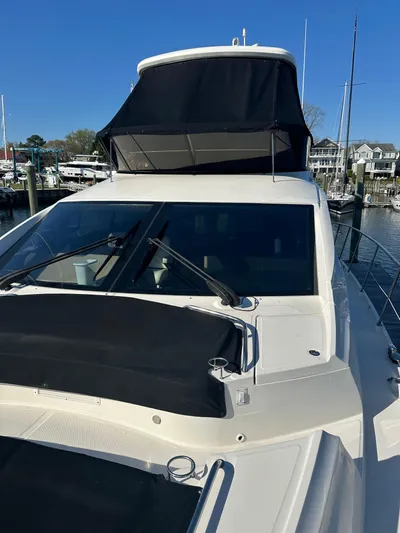 Working Late Yacht Photos Pics 2016 Sea Ray L590 Fly yacht docked at marina, featuring sleek design and flybridge.