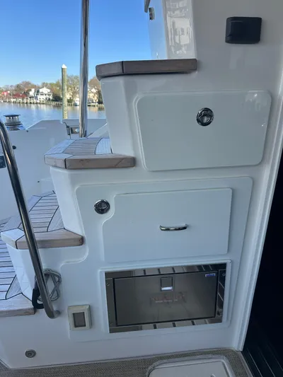 Working Late Yacht Photos Pics 2016 Sea Ray L590 Fly yacht stairs and storage compartments by the water.