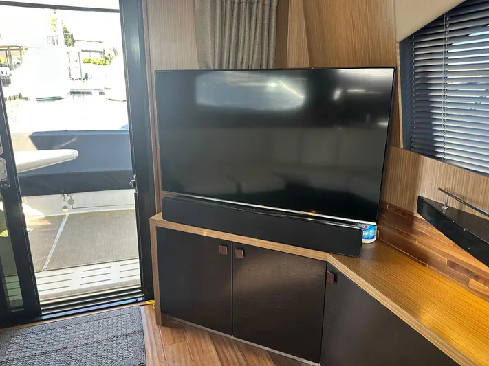 Working Late Yacht Photos Pics Interior of 2016 Sea Ray L590 Fly yacht with TV and modern wood cabinetry.