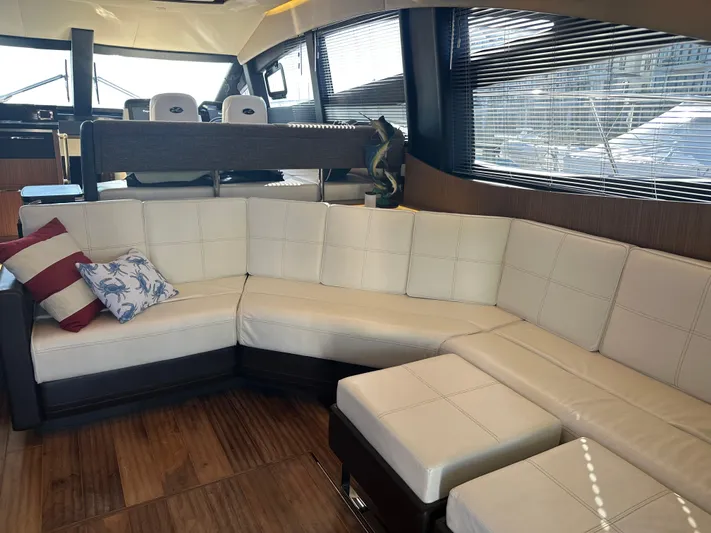 Working Late Yacht Photos Pics Luxurious interior of 2016 Sea Ray L590 Fly yacht with plush seating and elegant design.