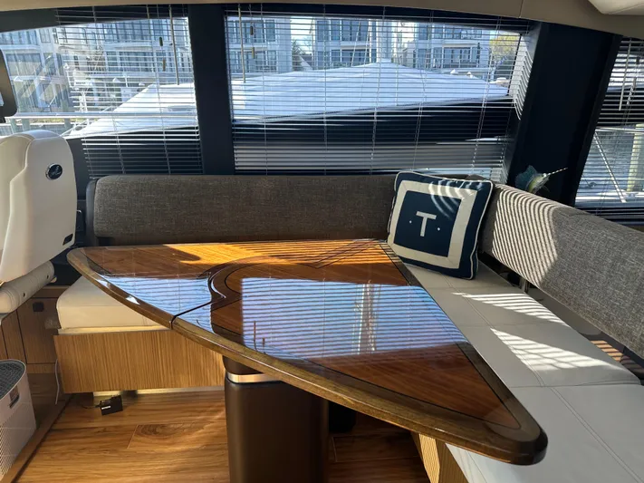 Working Late Yacht Photos Pics Luxurious interior of 2016 Sea Ray L590 Fly yacht with elegant wooden table and seating.