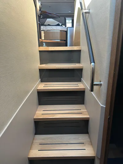 Working Late Yacht Photos Pics Staircase inside 2016 Sea Ray L590 Fly yacht with wooden steps and metal handrail.