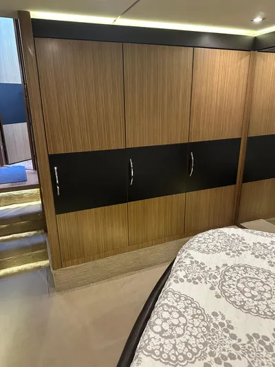 Working Late Yacht Photos Pics 2016 Sea Ray L590 Fly yacht interior with wood paneling and patterned bedding.