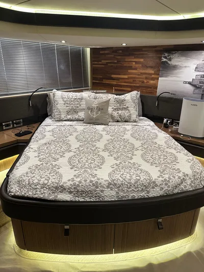 Working Late Yacht Photos Pics Luxurious bedroom interior of 2016 Sea Ray L590 Fly yacht with elegant bedding and ambient lighting.