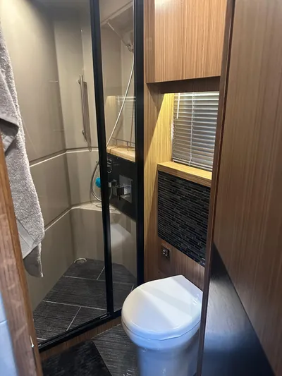 Working Late Yacht Photos Pics 2016 Sea Ray L590 Fly yacht bathroom with modern shower and toilet.
