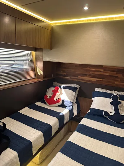 Working Late Yacht Photos Pics 2016 Sea Ray L590 Fly cabin with twin beds, nautical decor, and ambient lighting.