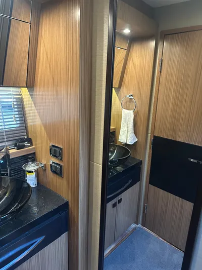 Working Late Yacht Photos Pics 2016 Sea Ray L590 Fly yacht bathroom with wood paneling and modern fixtures.