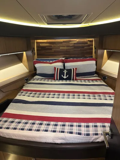 Working Late Yacht Photos Pics Luxurious 2016 Sea Ray L590 Fly yacht bedroom with nautical-themed bedding.