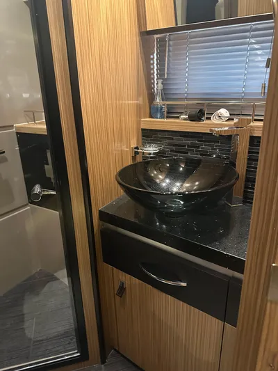 Working Late Yacht Photos Pics Luxurious bathroom in 2016 Sea Ray L590 Fly yacht with modern glass sink.
