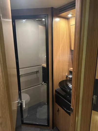 Working Late Yacht Photos Pics 2016 Sea Ray L590 Fly yacht bathroom with glass shower door and modern sink.