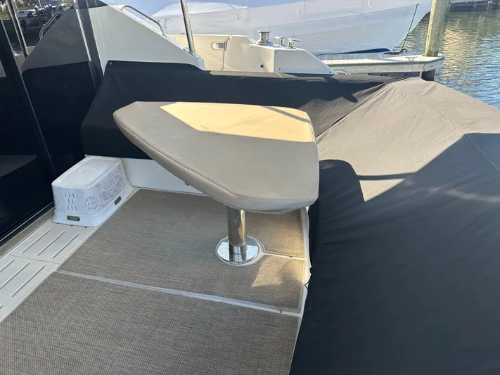 Working Late Yacht Photos Pics 2016 Sea Ray L590 Fly yacht deck with cushioned seating and table.