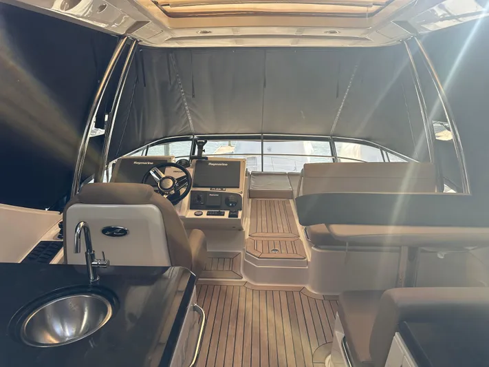 Working Late Yacht Photos Pics Interior of 2016 Sea Ray L590 Fly yacht with modern helm and seating area.